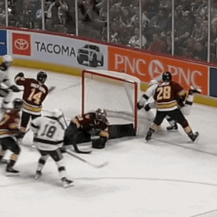 a hockey game is being played in front of an advertisement for tacoma and pnc