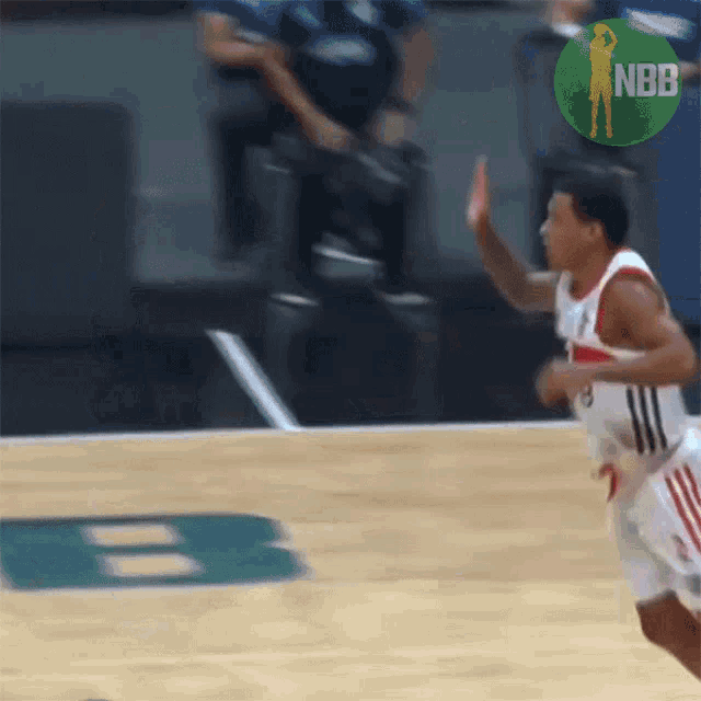 a basketball player on a court with a nbb logo in the background