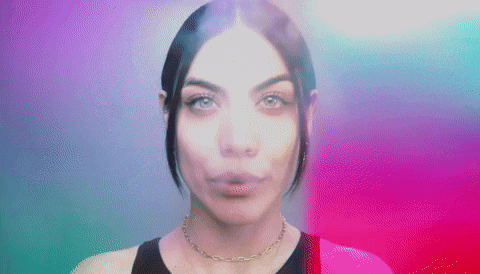 a close up of a woman 's face with a necklace on a colorful background .