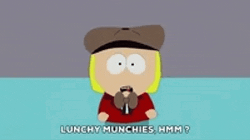 a cartoon character from south park is sitting at a table with a microphone .