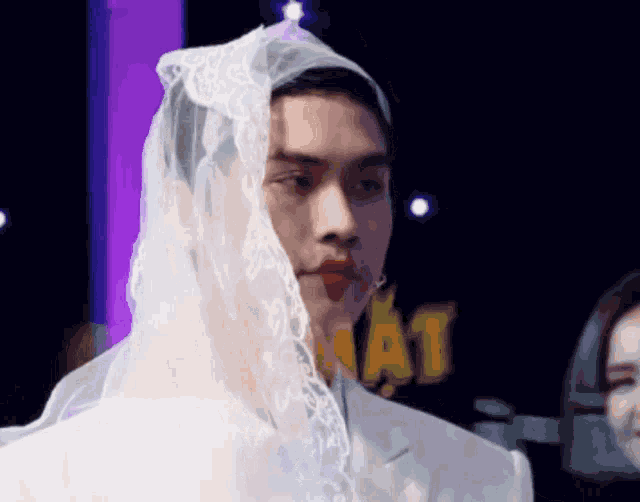 a man with a veil on his head and red lipstick