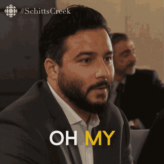 a man with a beard says " oh my " in front of him