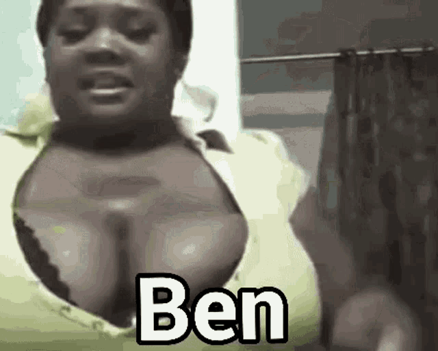 a woman with very large breasts is standing in front of a shower curtain with the name ben written on it .