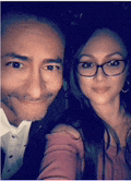 a man and a woman are posing for a picture together .