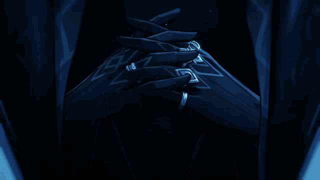 a man with glasses and a black cape is smiling