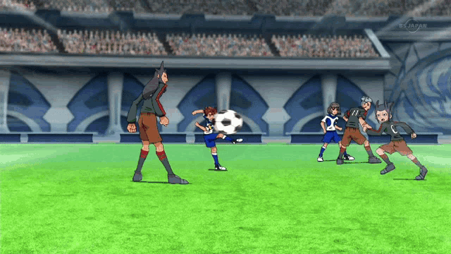 a group of soccer players are playing on a field with a tv screen behind them that says tokyo