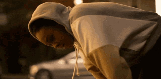 a person wearing a hoodie is looking down