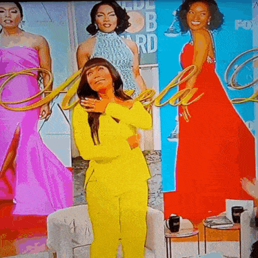 a woman in a yellow suit is standing in front of a poster for the fox network