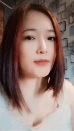 a close up of a woman 's face with red hair