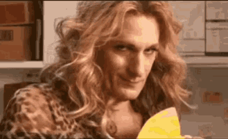 a woman in a leopard print coat is holding a piece of cheese .