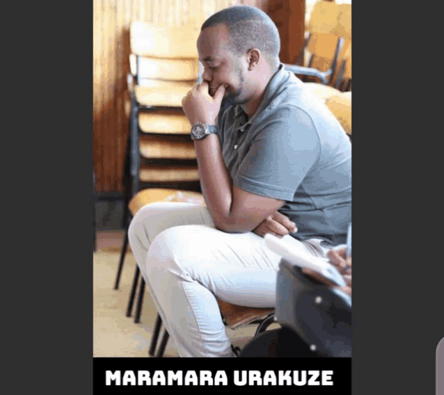 a man sitting in a chair with the name maramara urakuze written below him