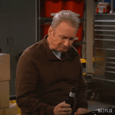 a man is holding a beer bottle and says i 'm gonna need about