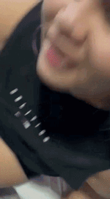 a close up of a person 's face with a black shirt that says ' nike ' on it
