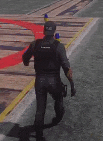 a man in a police uniform is walking down a street with a gun in his hand .