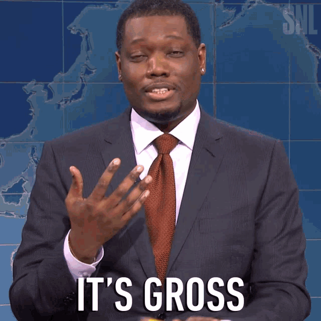 a man in a suit and tie says it 's gross in front of a map