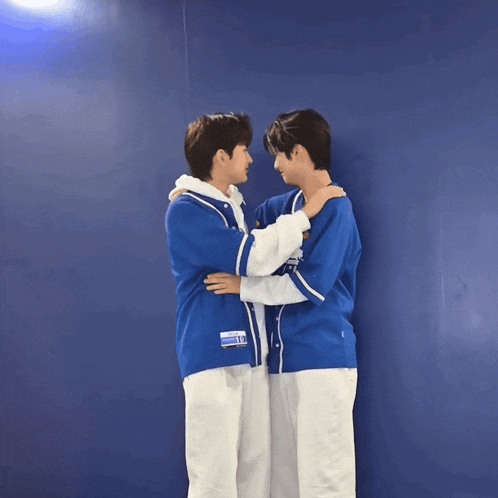 two boys wearing blue jerseys with team r on them
