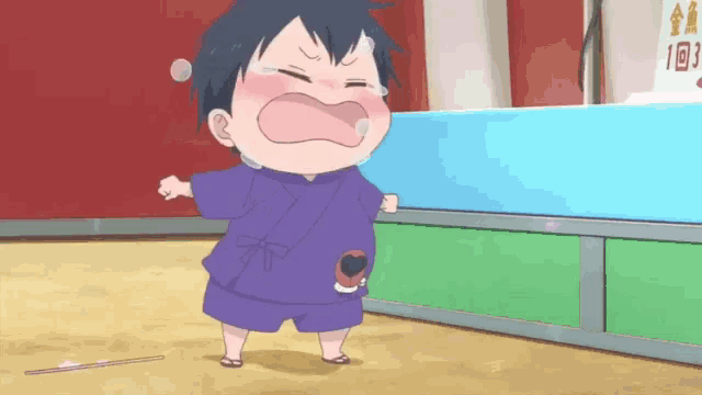 a little boy in a purple shirt is crying while holding a stick .