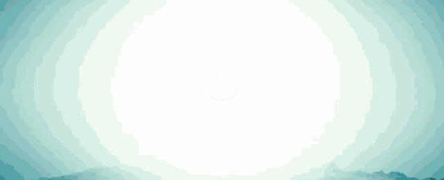 a person standing on top of a mountain with the sun behind them