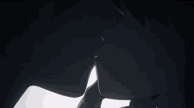 a silhouette of a man and a woman kissing in the dark .