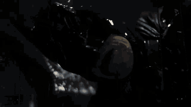 a man is laying on the ground in a dark room with lights behind him