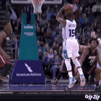a basketball game is being played in front of an american airlines advertisement