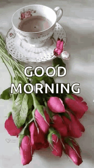 a cup of coffee and a bouquet of pink roses on a saucer with the words `` good morning '' .