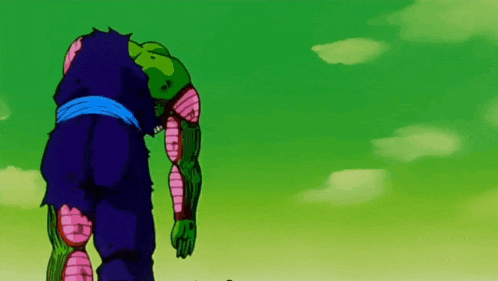 piccolo from dragon ball z is standing with his head down in the dirt .