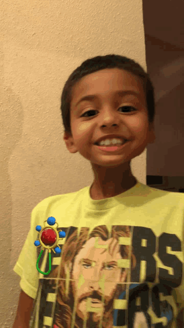 a young boy wearing a yellow shirt that says jesus on it