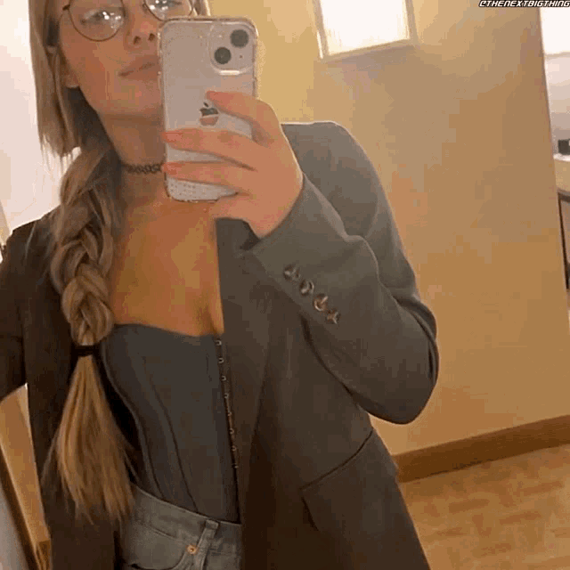 a woman taking a picture of herself in a mirror with a watermark that says @thenextstar