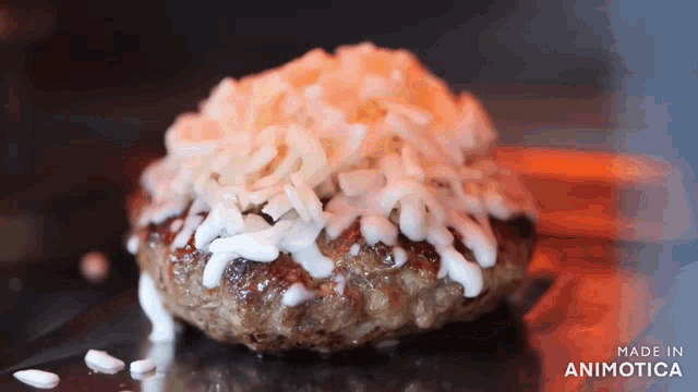 a close up of a hamburger with cheese and mayonnaise on it