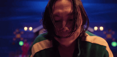 a close up of a person 's face with long hair .