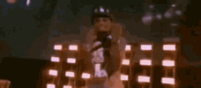 a man is standing on a stage holding a microphone in his hand .