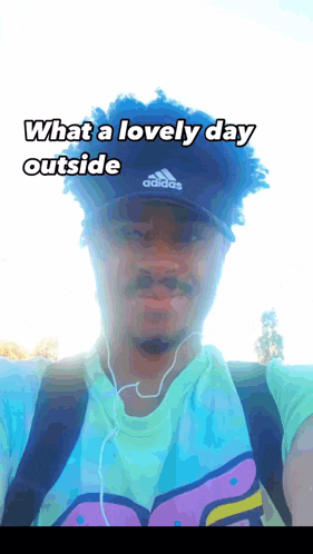 a man is wearing an adidas hat and ear buds
