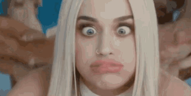 a close up of a woman making a funny face with her mouth open .