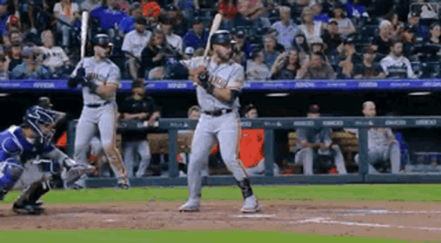 a baseball player is getting ready to swing his bat at a ball