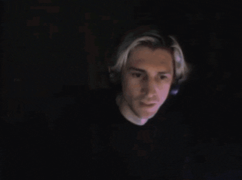 a blurry picture of a man 's face with a headset on .