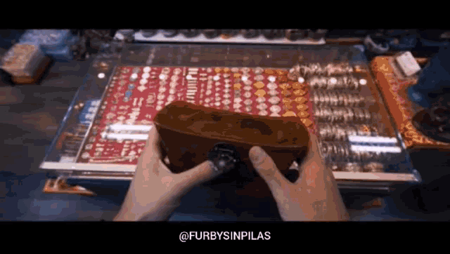 a person is holding a brick in front of a display of jewelry with the hashtag furbysinpilas at the bottom