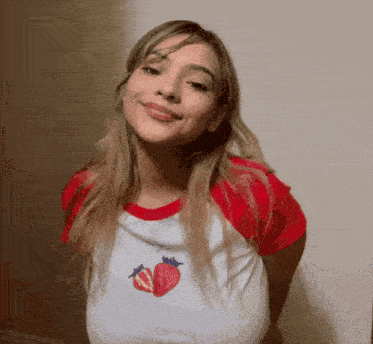 a woman in a red and white shirt with strawberries on it