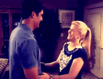 a man and a woman are holding hands and smiling