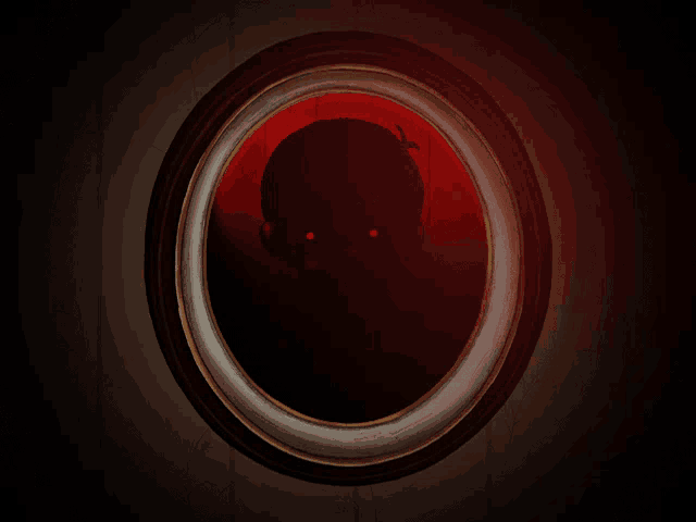 a picture frame with a silhouette of a person with red eyes in it