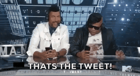 two men are sitting at a table looking at their cell phones and the caption says that 's the tweet .
