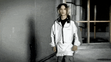 a young man wearing a white jacket with the word columbia on it