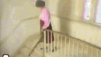 a person is walking up the stairs in a building .