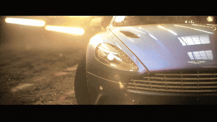 a close up of a car 's headlight with the word aston martin on it