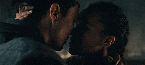 a man and a woman are looking at each other with their eyes closed