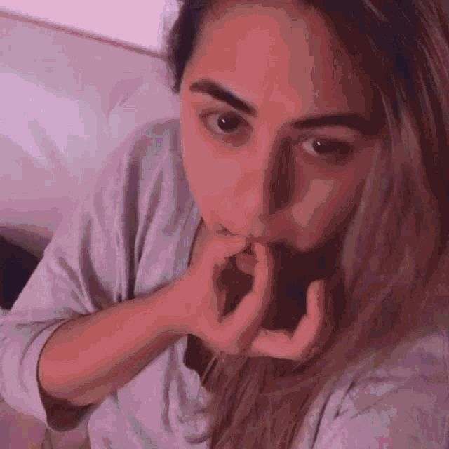 a close up of a woman eating a piece of chocolate .