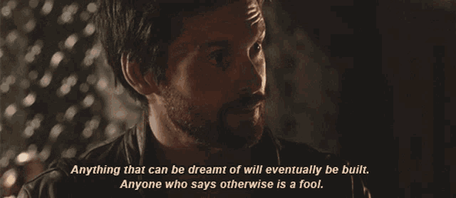 a man with a beard and a quote that says anything that can be dreamt of will eventually be built