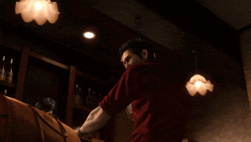 a man in a red shirt is holding a piece of paper with a snake on his face