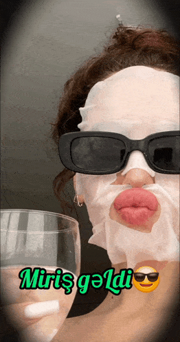 a woman with a mask on her face is holding a wine glass