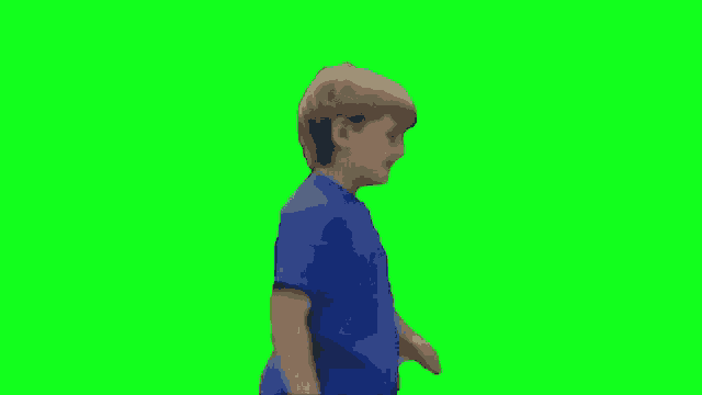 a young boy in a blue t-shirt is dancing on a green screen .